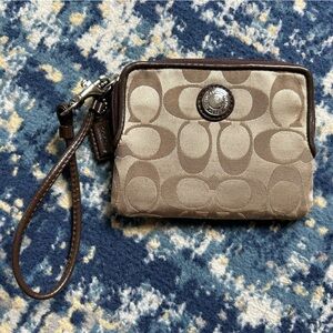 Coach wristlet with coin pocket and cardholders.